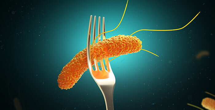 illustration d'une fourchette plantée dans un microbe intestinal