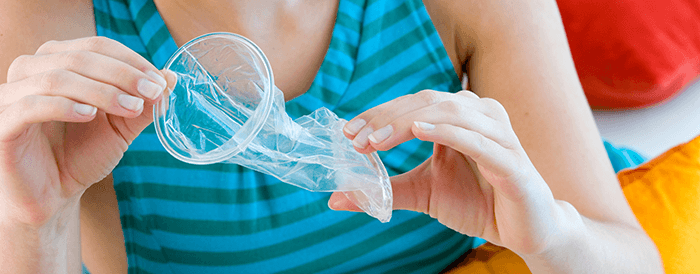 préservatif féminin déployé présenté par une femme