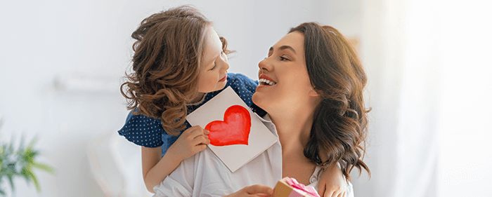 petite fille offrant une carte à sa maman