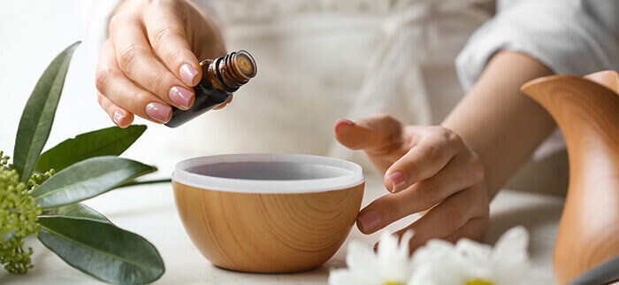 flacon d'huile essentielle au dessus d'un bol