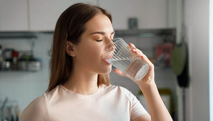 femme qui boit un verre d'eau