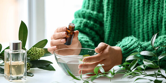 femme préparant un mélange pour inhalation d'huiles essentielles