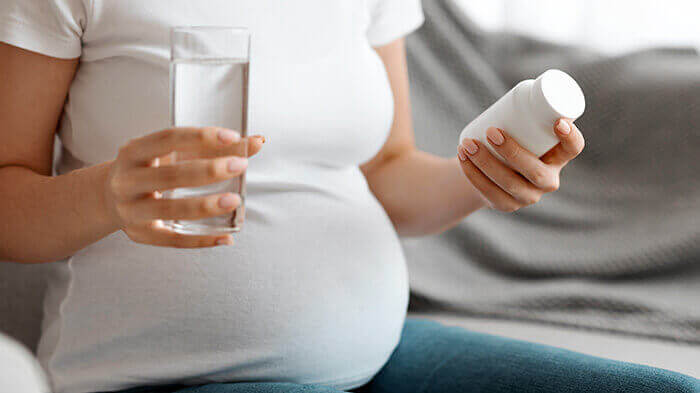 femme enceinte s'apprêtant à prendre du paracétamol